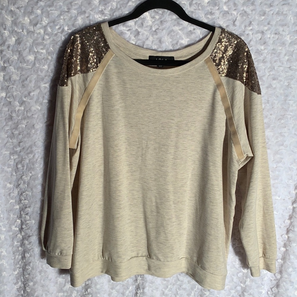 Sequin covers shoulders on this natural tone Tee